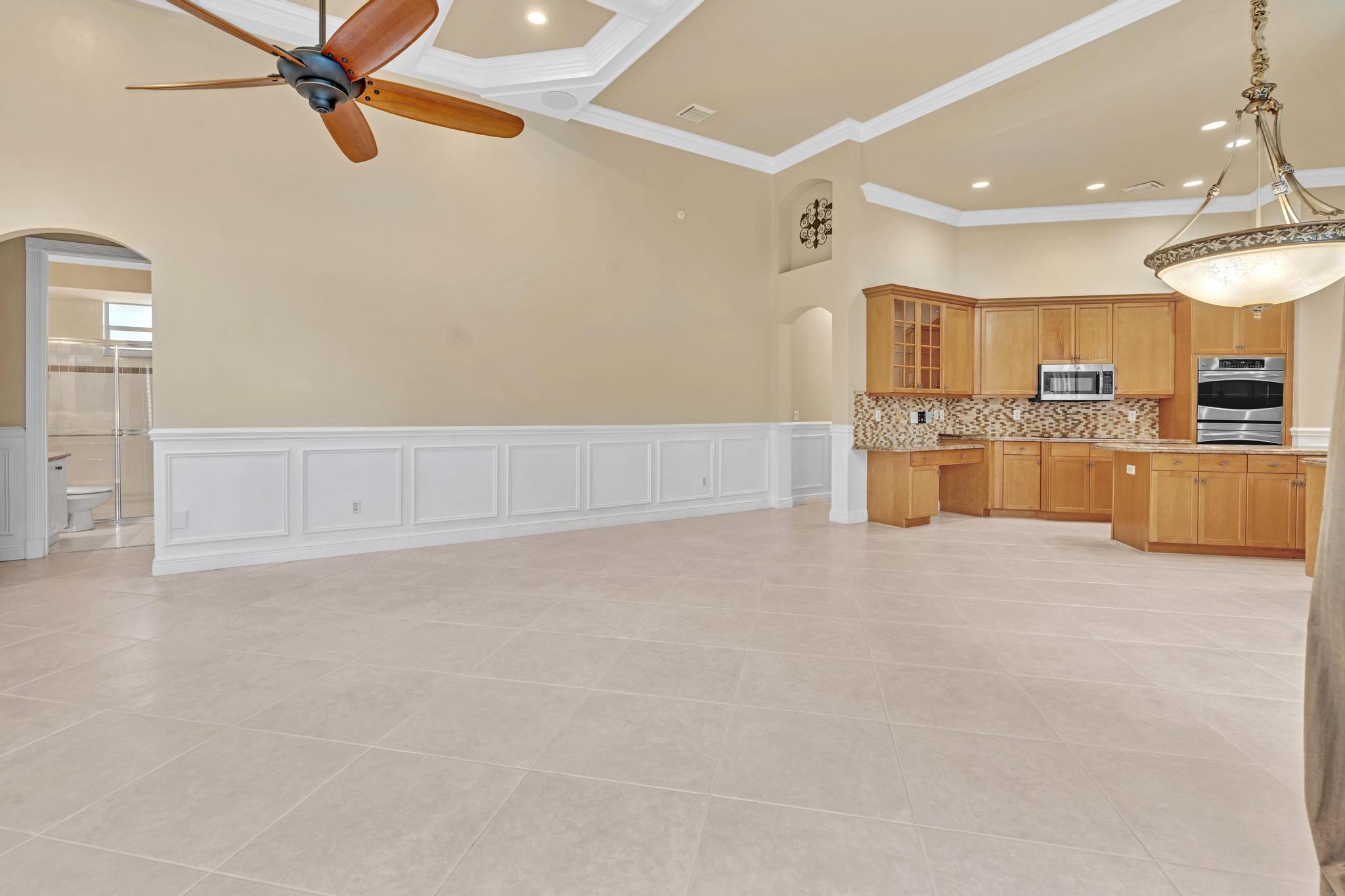11604 Kensington Court Boca Raton, FL 33428 - Photo 53 of 81 a kitchen with refrigerator and cabinets