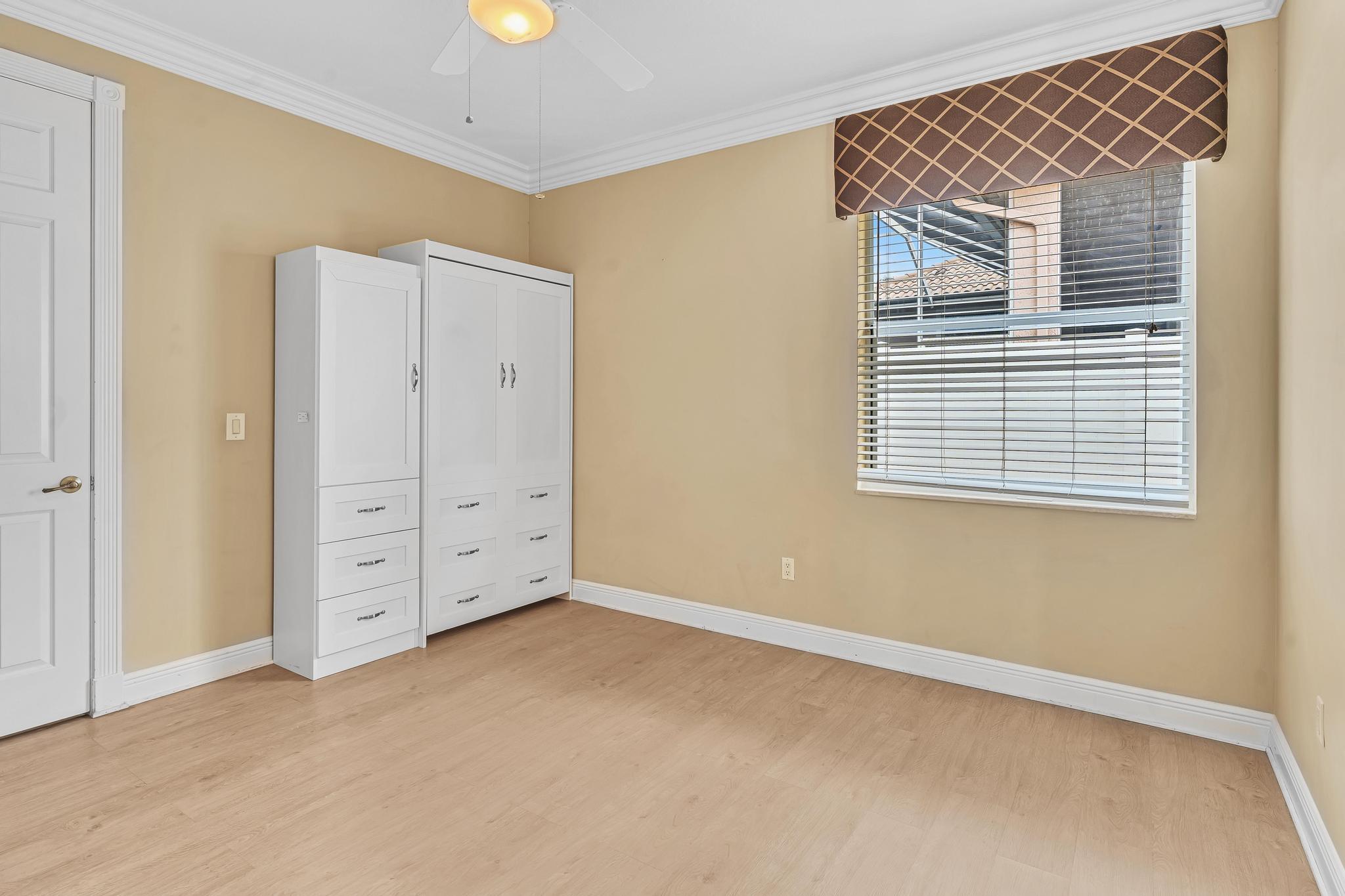 11604 Kensington Court Boca Raton, FL 33428 - Photo 63 of 81 a view of an empty room with window and cabinet