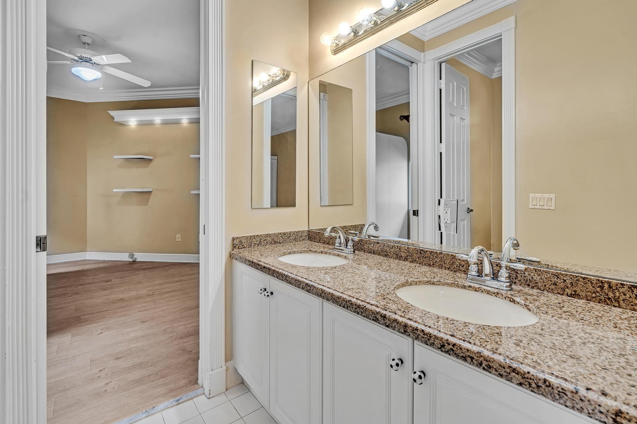 11604 Kensington Court Boca Raton, FL 33428 - Photo 65 of 81 a bathroom with a granite countertop sink and a mirror