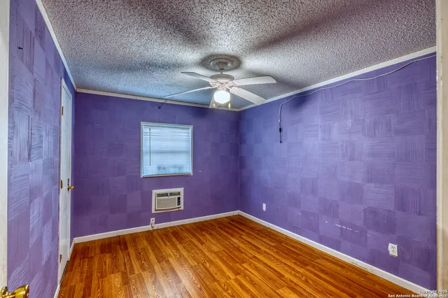 a view of empty room with a ceiling fan and window