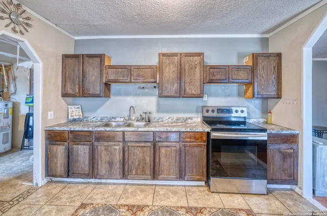 a kitchen with stainless steel appliances granite countertop a stove and a cabinets