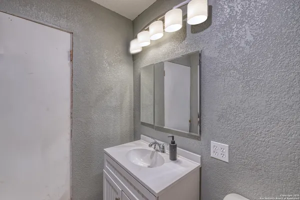 a bathroom with a sink and a mirror