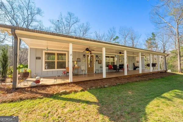 a view of a house with backyard porch and sitting area