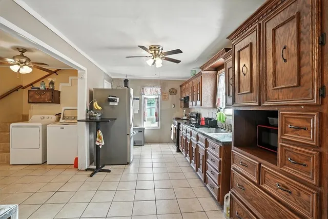 a kitchen with stainless steel appliances kitchen island granite countertop lots of counter top space and cabinets