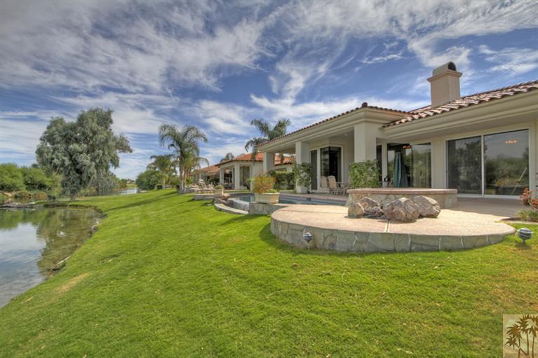 231 Loch Lomond Road Rancho Mirage, CA 92270 - Photo 3 of 25 a view of a house with a big yard potted plants and large tree