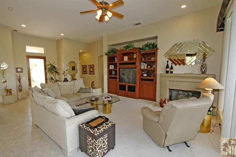 231 Loch Lomond Road Rancho Mirage, CA 92270 - Photo 6 of 25 a living room with furniture a lamp and a chandelier