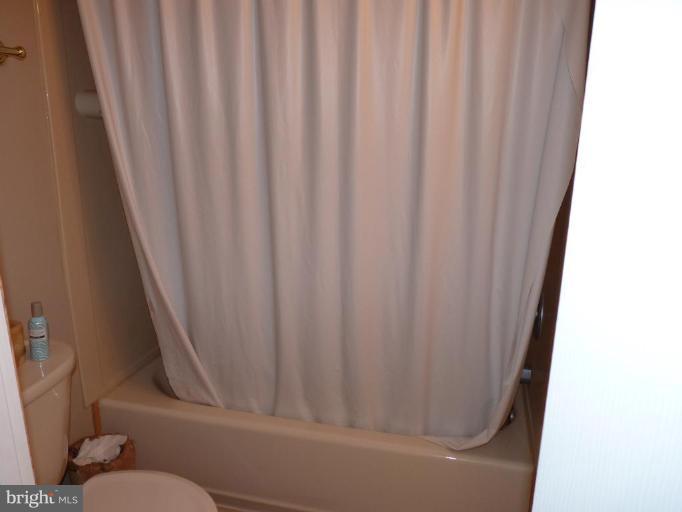 17420 Hughes Road Poolesville, MD 20837 - Photo 21 of 21 a bathroom with a shower curtain and sink