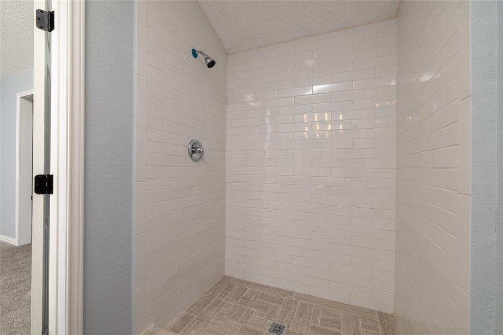 2513 Poplar Spring Road Fort Worth, TX 76123 - Photo 30 of 40 Walk-in shower with subway tile surround, tiled flooring, and chrome fixtures