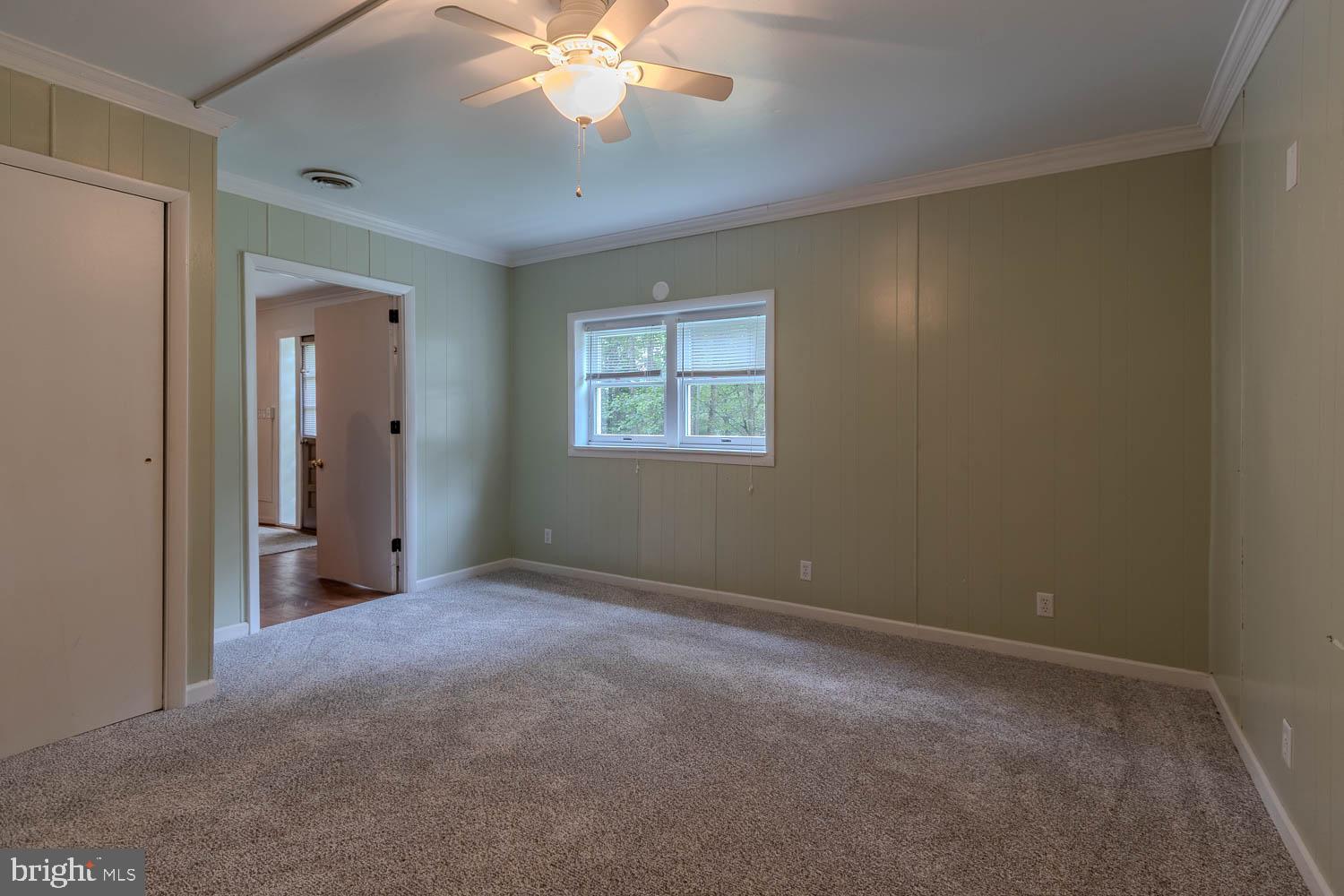 14742 Happy Hills Road Huntingdon, PA 16652 - Photo 24 of 48 an empty room with a chandelier fan and windows