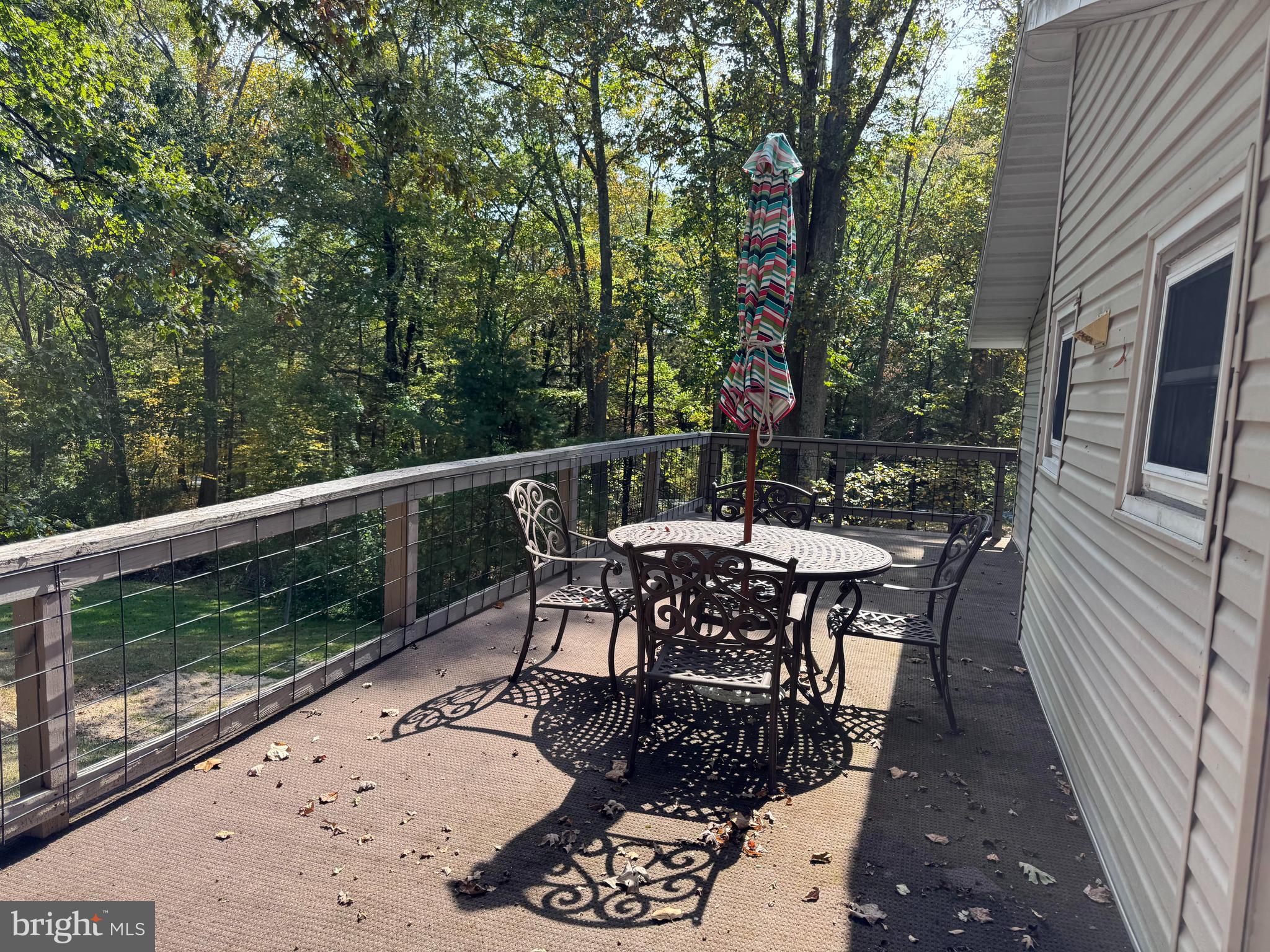 14742 Happy Hills Road Huntingdon, PA 16652 - Photo 28 of 48 a view of a patio with table and chairs with wooden floor and fence