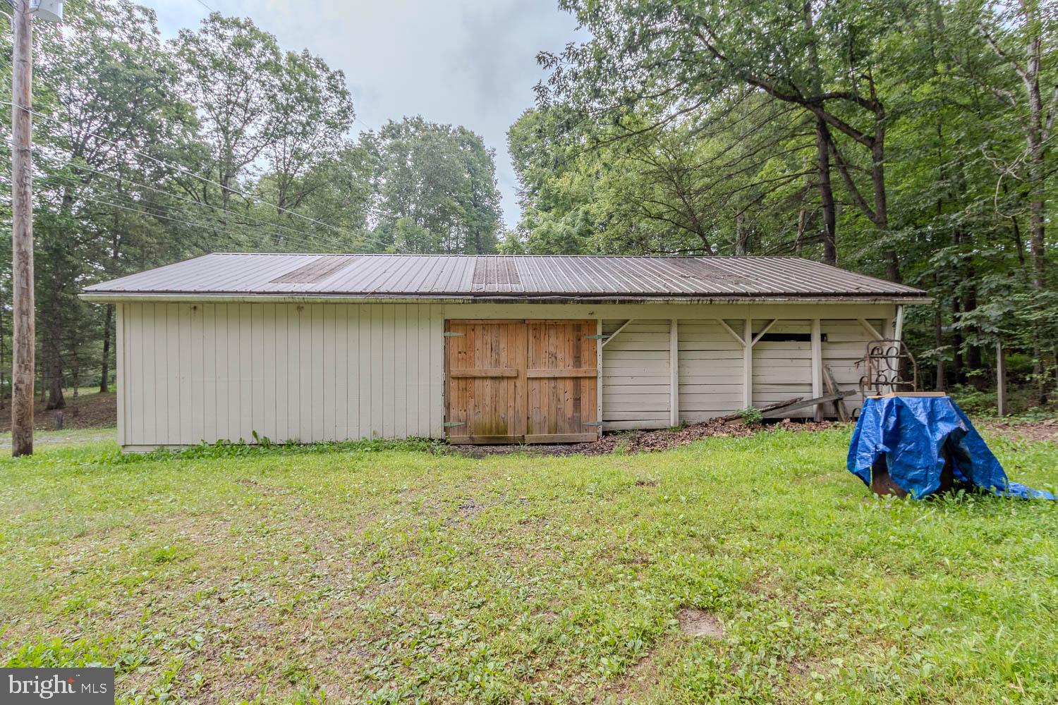 14742 Happy Hills Road Huntingdon, PA 16652 - Photo 38 of 48 a view of a house with a garden and yard