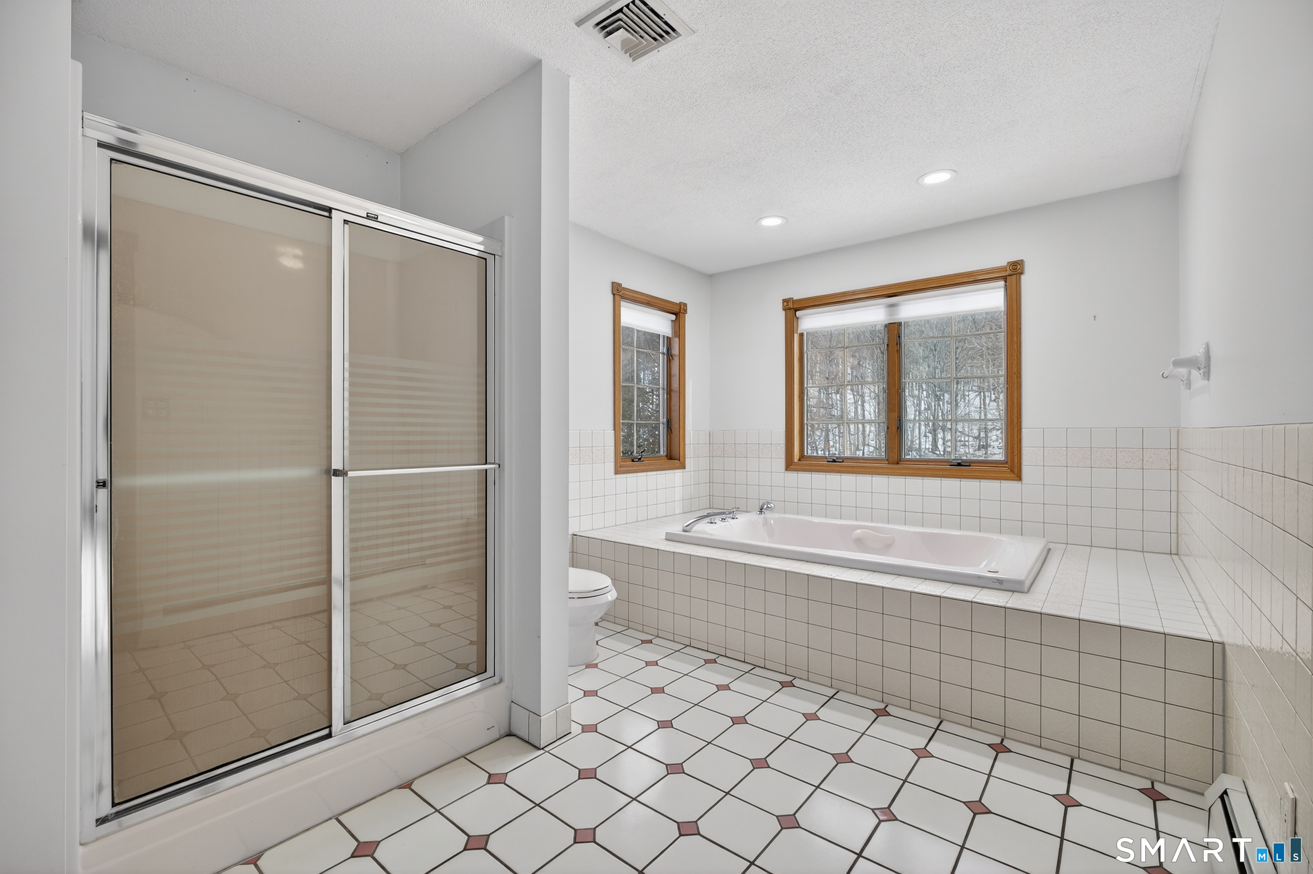 61 Edwards Road Bethany, CT 06524 - Photo 15 of 40 a bathroom with a bathtub and a shower
