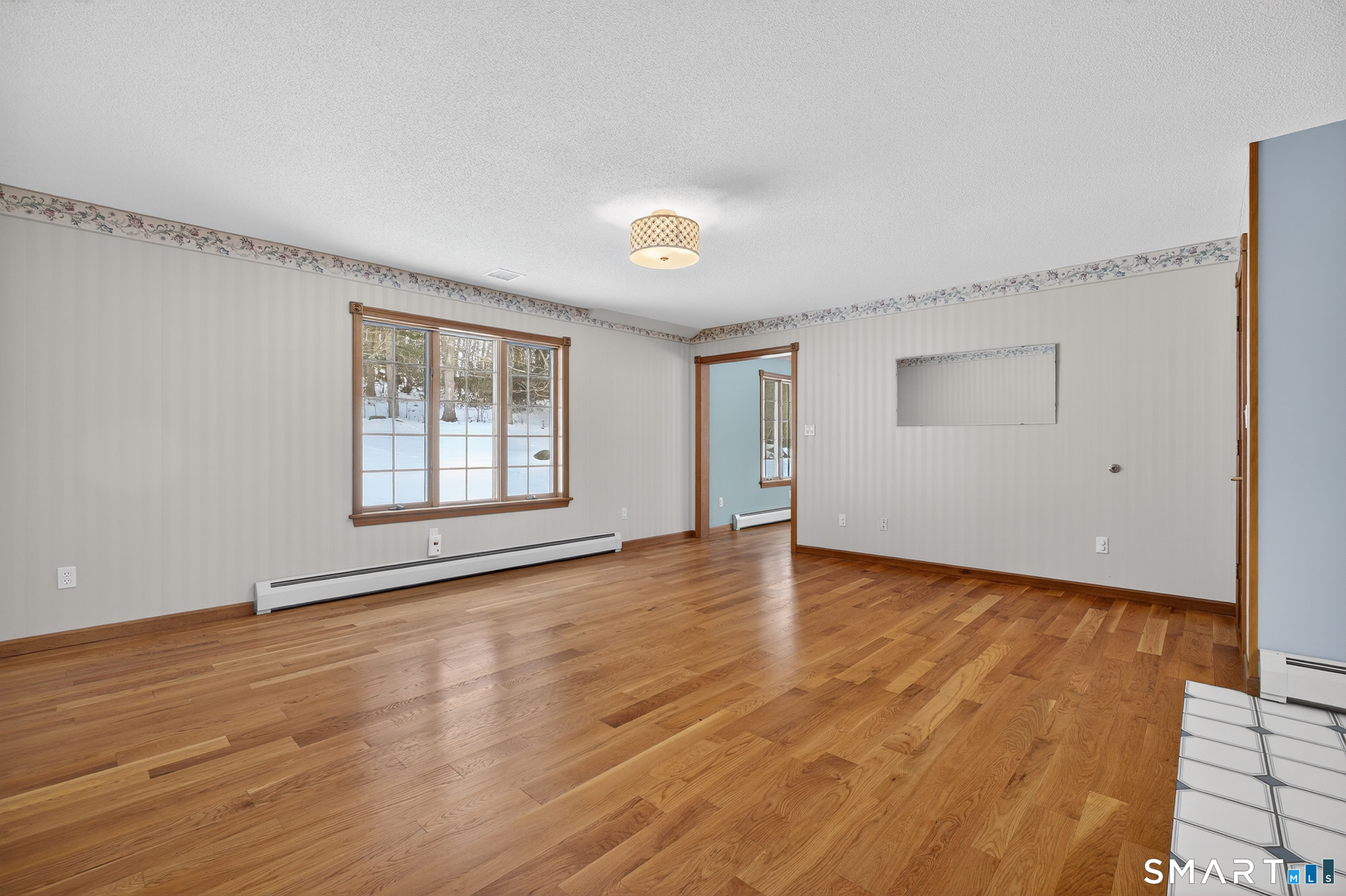 61 Edwards Road Bethany, CT 06524 - Photo 28 of 40 an empty room with wooden floor and windows