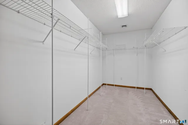 a spacious bathroom with a granite countertop sink a mirror and a shower
