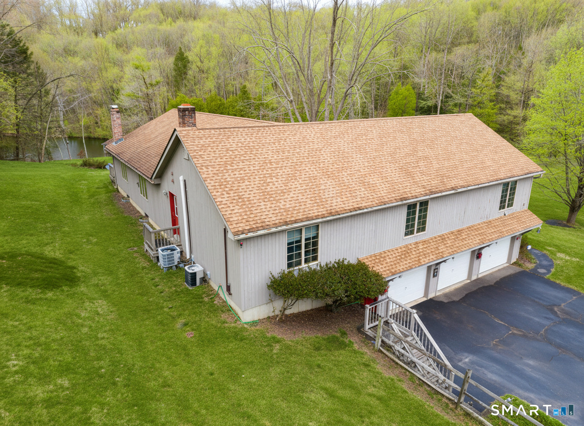 61 Edwards Road Bethany, CT 06524 - Photo 3 of 40 an aerial view of a house with a yard table and chairs