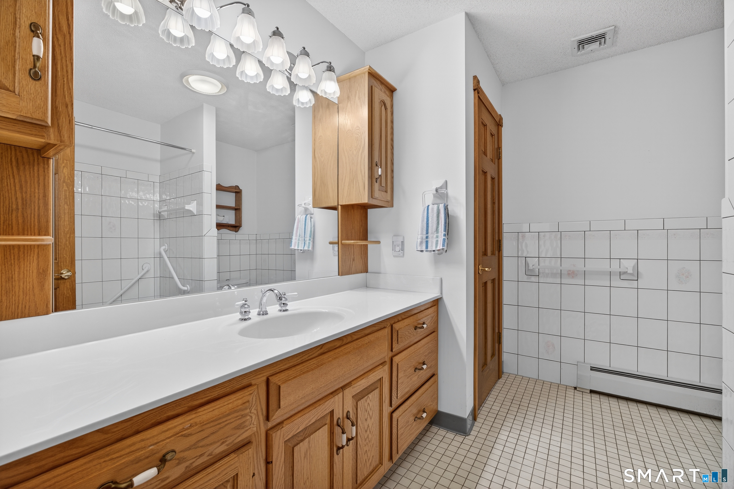 61 Edwards Road Bethany, CT 06524 - Photo 32 of 40 a bathroom with a sink a double vanity and a mirror