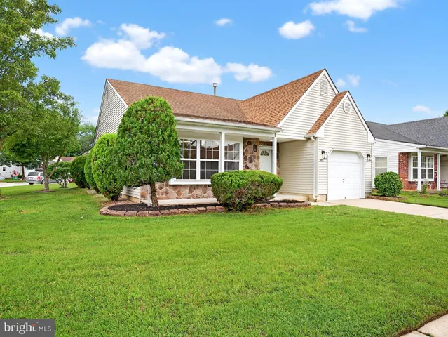 a view of a house with a yard and sitting area