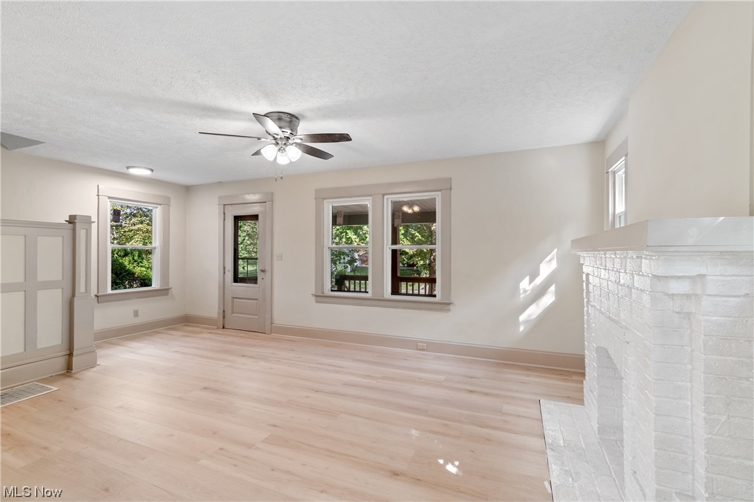 1474 Hampton Road Akron, OH 44305 - Photo 7 of 27 Living room with ceiling fan, light hardwood floors, and a textured ceiling