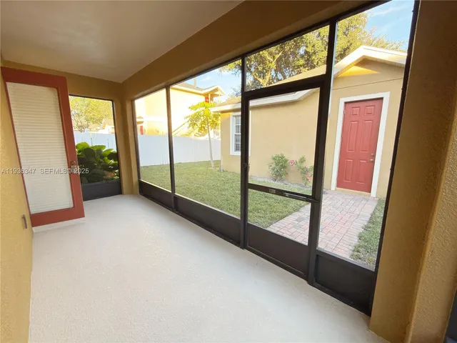 a view of an empty room with large windows