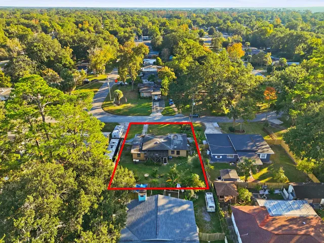 an aerial view of a houses with yard