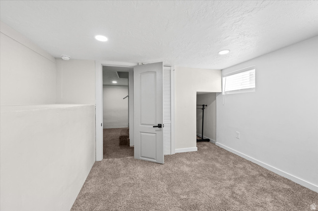 327 35th Street Ogden, UT 84401 - Photo 24 of 31 Carpeted room with a white door and a window