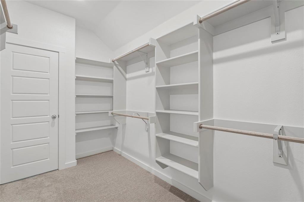 507 Avocet Road Princeton, TX 75407 - Photo 25 of 31 Built-in shelving, hanging rods, carpet flooring, and a five-panel interior door