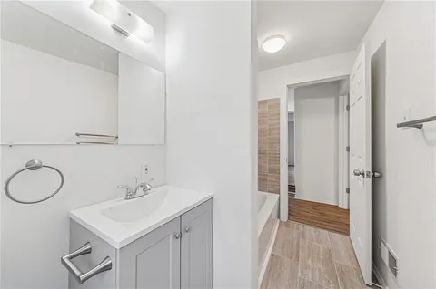 a bathroom with a sink vanity granite and a mirror