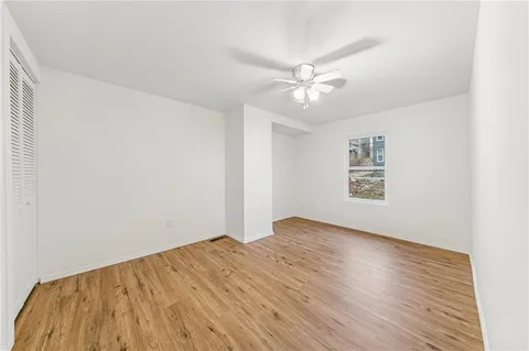 a view of empty room with wooden floor