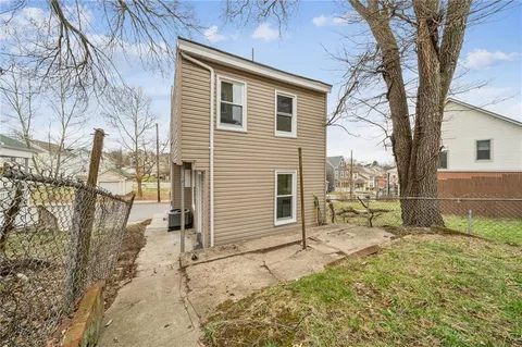 a view of a house with a yard and the trees