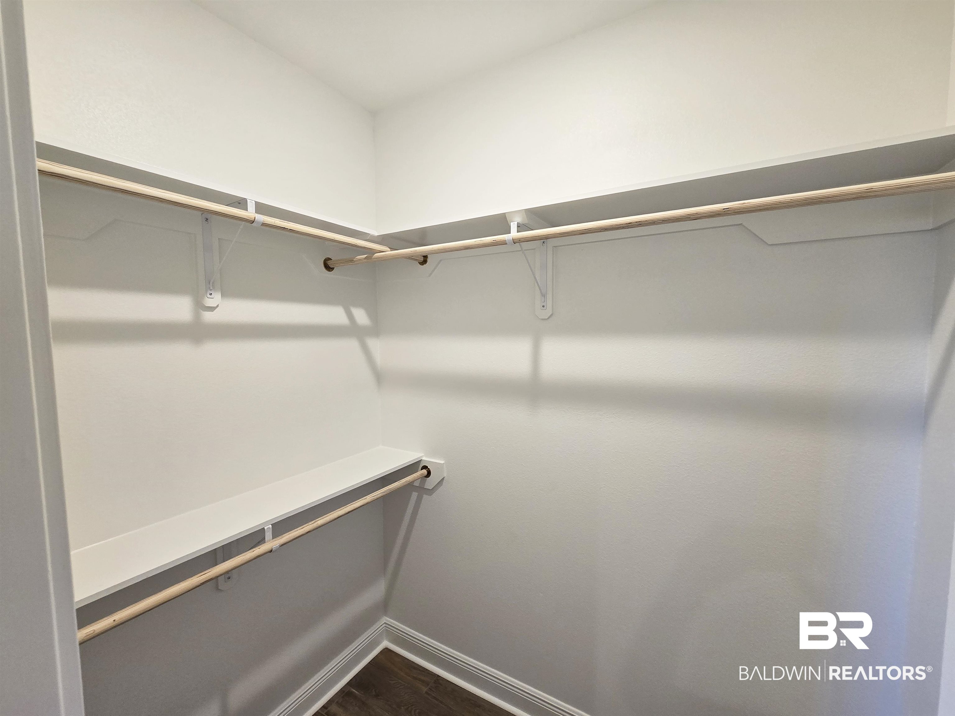 11178 Bonaventure Avenue Daphne, AL 36526 - Photo 13 of 20 Walk in closet with dark wood-style flooring