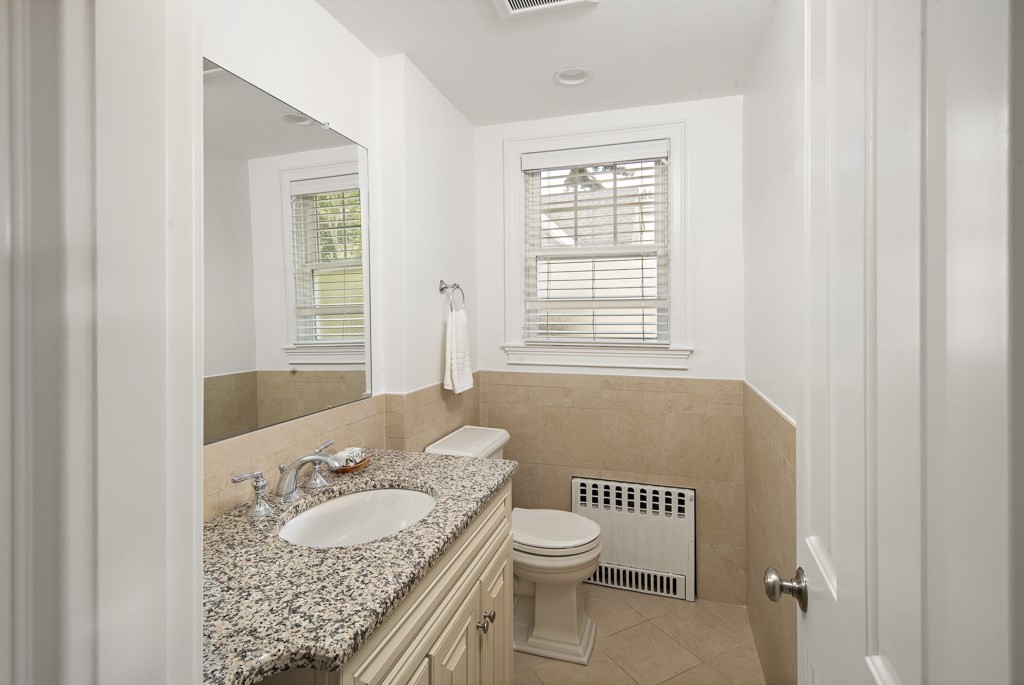 106 Florence Avenue Arlington, MA 02476 - Photo 12 of 32 a bathroom with a granite countertop sink and a toilet