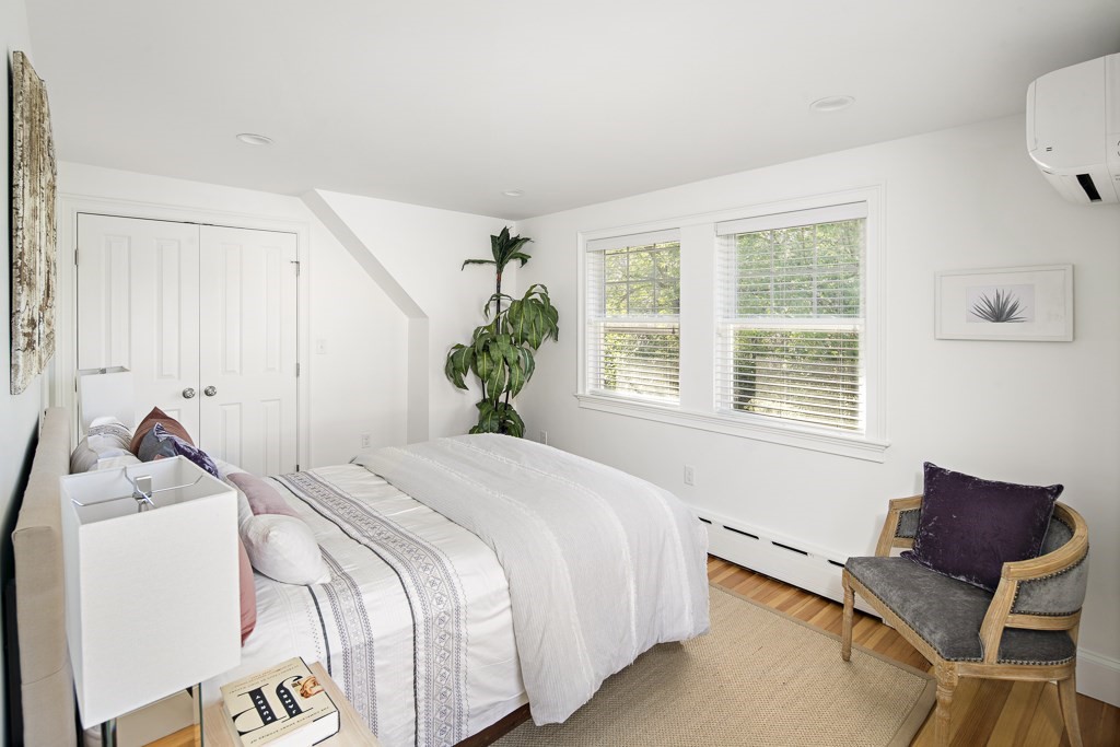106 Florence Avenue Arlington, MA 02476 - Photo 21 of 32 a bedroom with a bed and a chair with the wooden floor