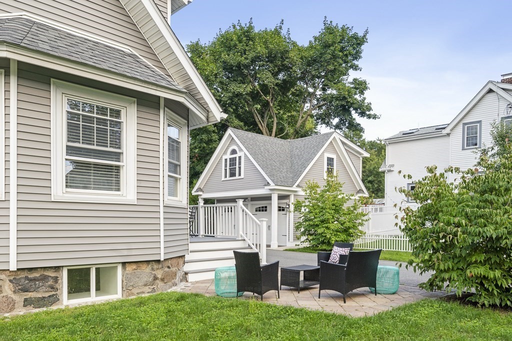 106 Florence Avenue Arlington, MA 02476 - Photo 29 of 32 a front view of a house with a yard and potted plants