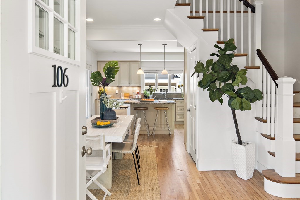 106 Florence Avenue Arlington, MA 02476 - Photo 3 of 32 a dining room with furniture potted plants and wooden floor