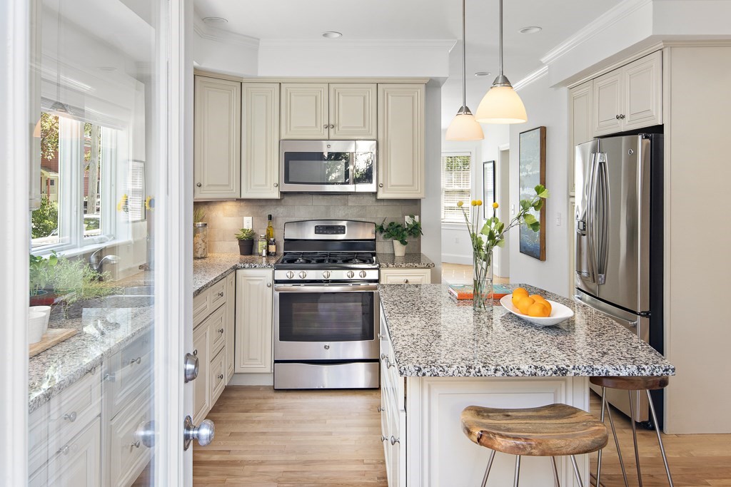 106 Florence Avenue Arlington, MA 02476 - Photo 8 of 32 a kitchen with stainless steel appliances kitchen island granite countertop a refrigerator a stove a sink and a stove