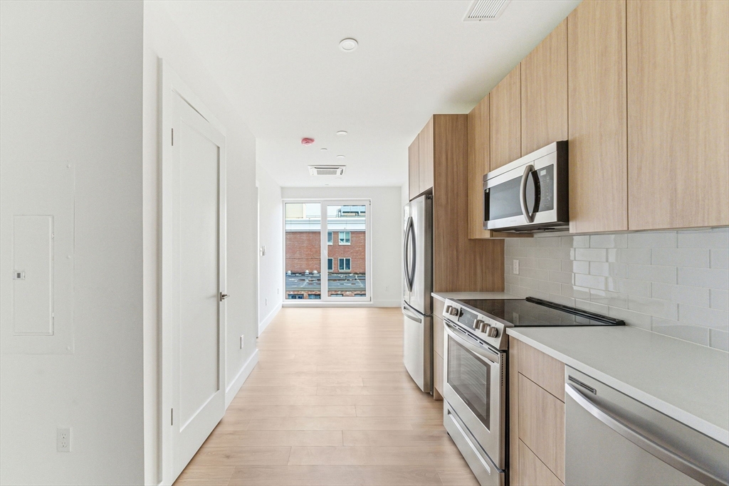 a kitchen with stainless steel appliances a refrigerator and a sink