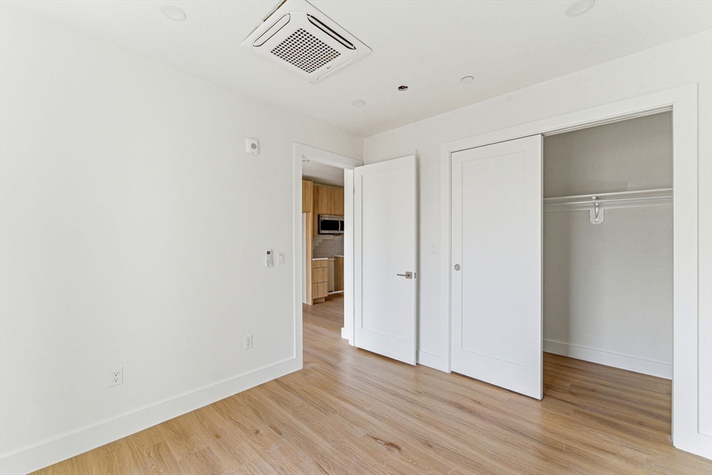 1035 Commonwealth Avenue, Unit 608 Boston, MA 02215 - Photo 4 of 13 a view of an empty room with wooden floor