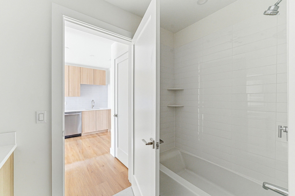 1035 Commonwealth Avenue, Unit 608 Boston, MA 02215 - Photo 7 of 13 a bathroom with a tub and shower
