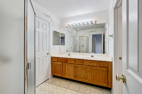 a spacious bathroom with a mirror sink and view