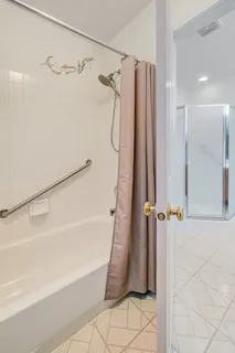 a bathroom with a shower and a glass door