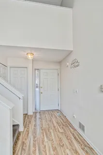 a view of a room with wooden floor
