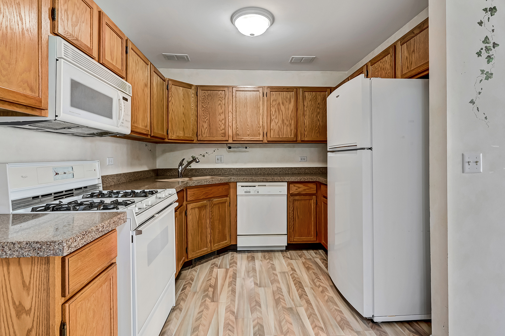945 Willow Street Itasca, IL 60143 - Photo 10 of 19 a kitchen with a refrigerator sink and stove top oven