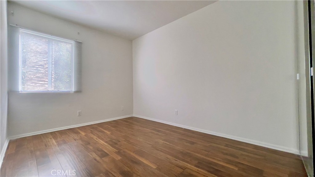 2911 4th Street, Unit 116 Santa Monica, CA 90405 - Photo 11 of 21 an empty room with wooden floor and windows