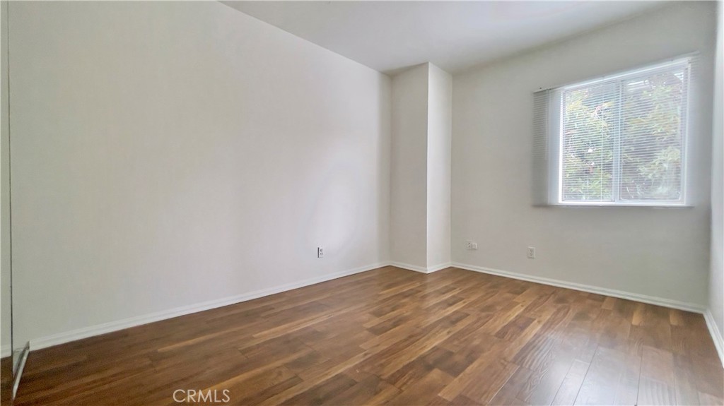 2911 4th Street, Unit 116 Santa Monica, CA 90405 - Photo 13 of 21 an empty room with wooden floor and windows