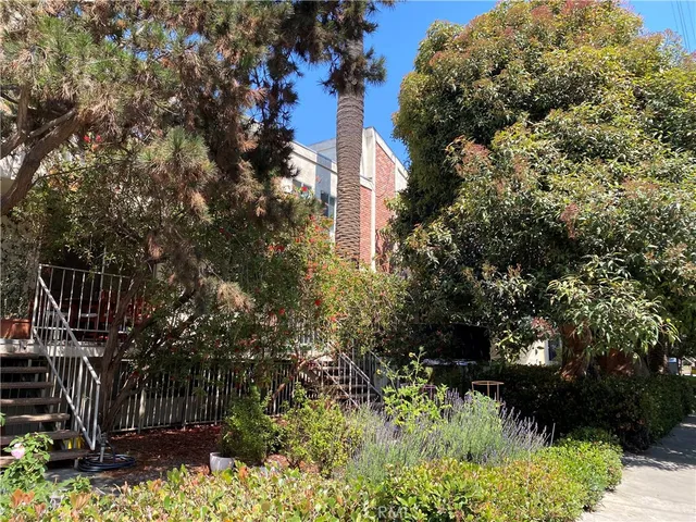 a couple of cars parked in front of a house
