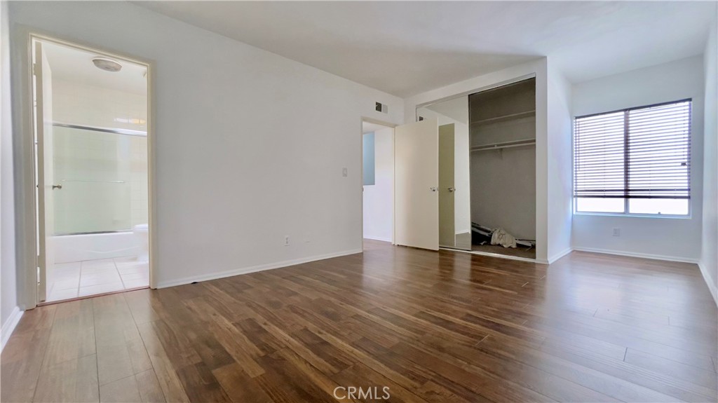 2911 4th Street, Unit 116 Santa Monica, CA 90405 - Photo 10 of 21 an empty room with wooden floor and windows