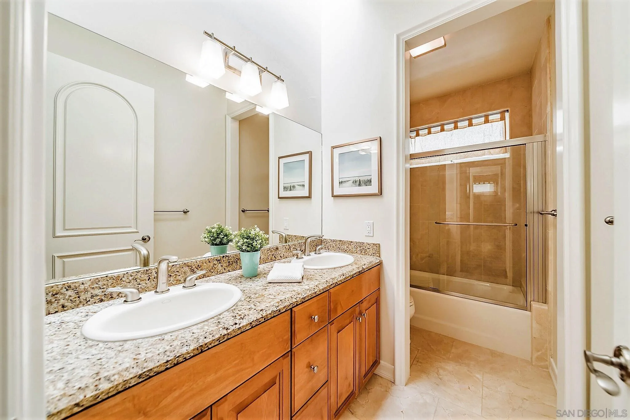 7558 Navigator Circle Carlsbad, CA 92011 - Photo 16 of 38 a bathroom with a granite countertop sink and a mirror