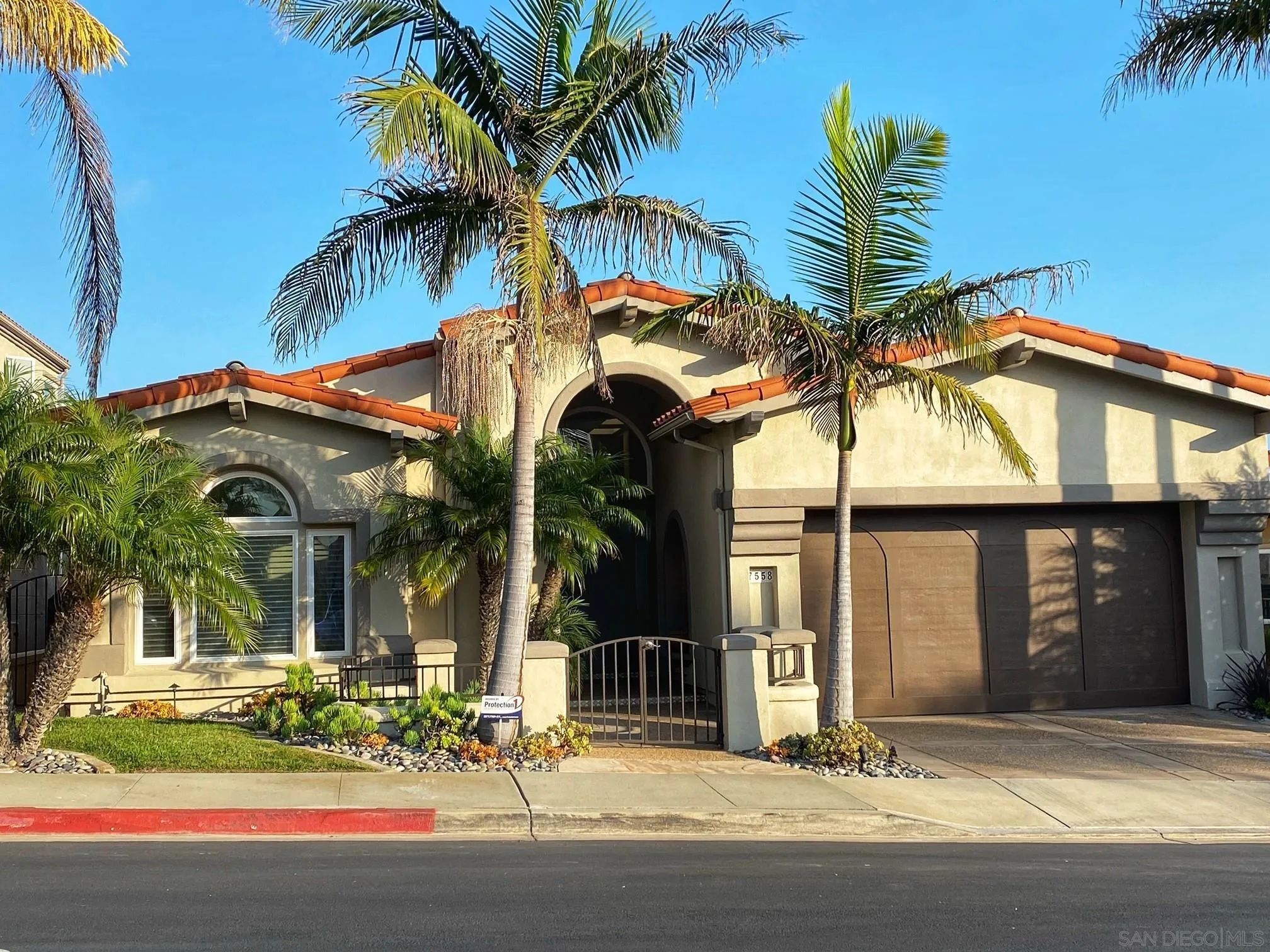 7558 Navigator Circle Carlsbad, CA 92011 - Photo 2 of 38 a view of a house with a yard and palm trees