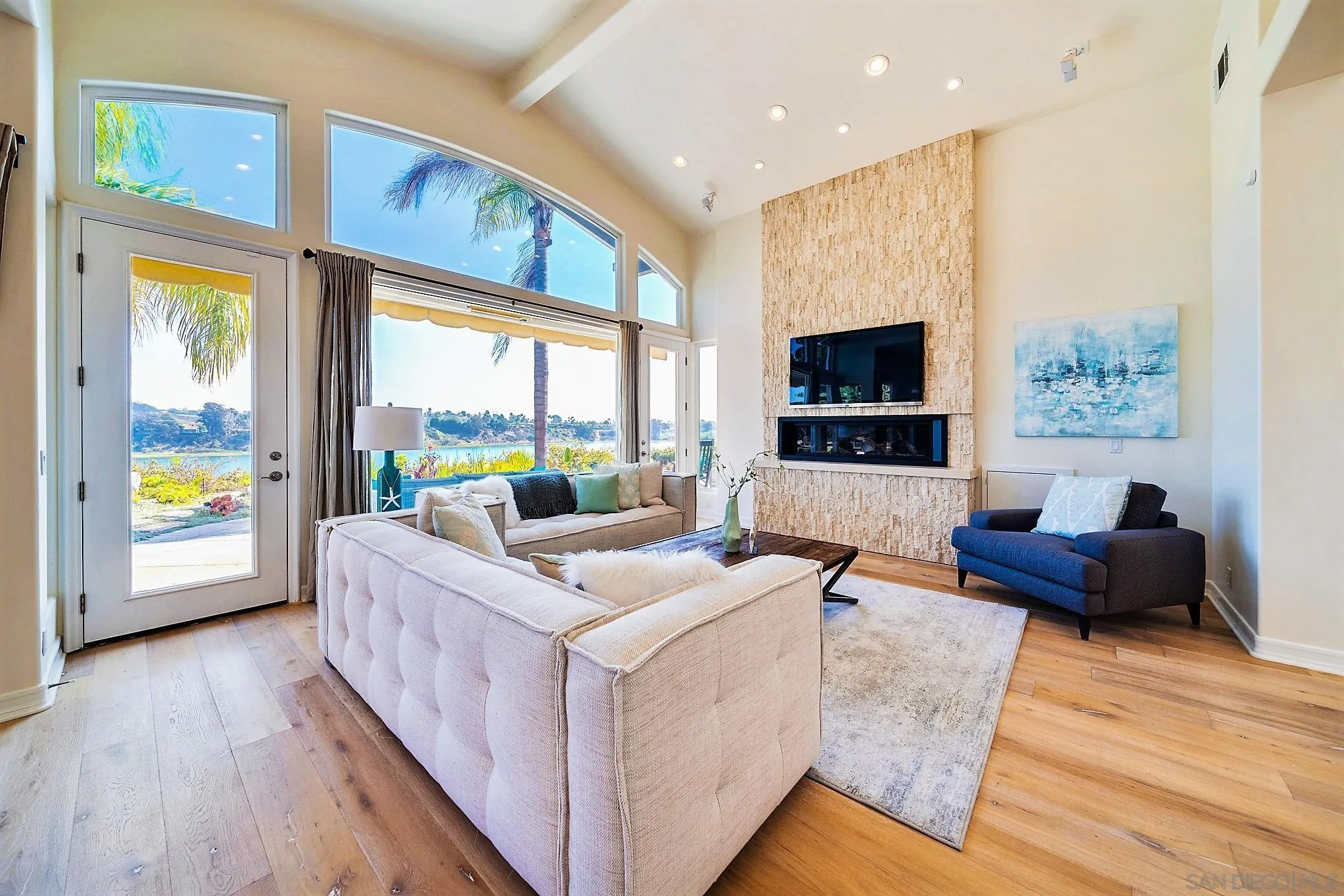 7558 Navigator Circle Carlsbad, CA 92011 - Photo 5 of 38 a living room with furniture fireplace and a flat screen tv