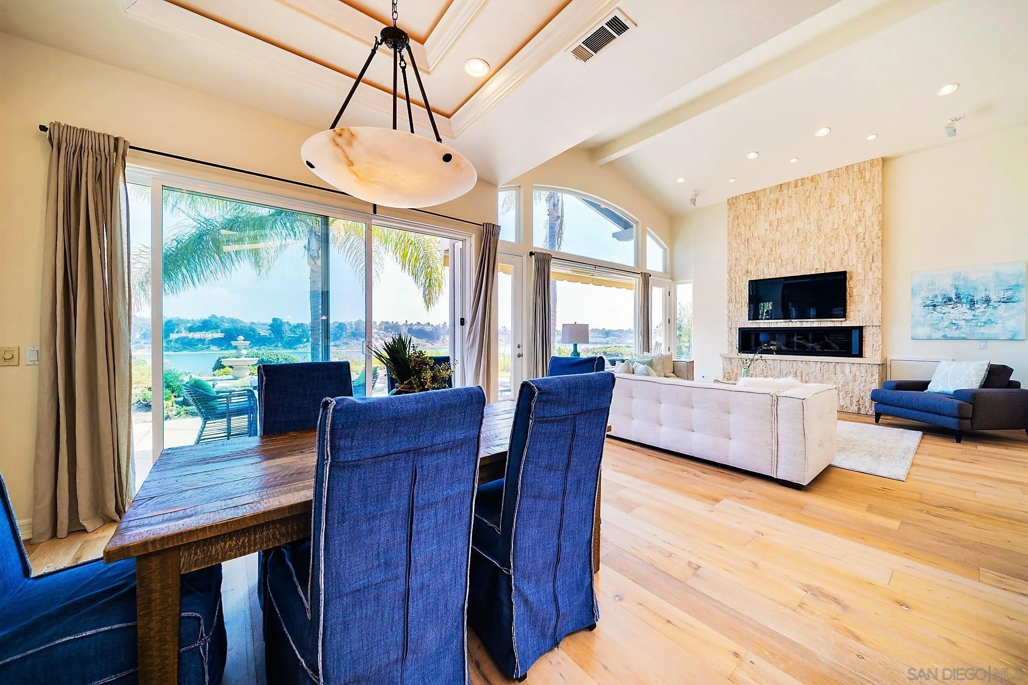7558 Navigator Circle Carlsbad, CA 92011 - Photo 7 of 38 a living room with furniture a flat screen tv and a large window